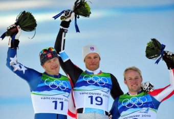 WHISTLER, BC - FEBRUARY 19:  (L-R) Bode Miller of the United States celebrates winning silver, Aksel Lund Svindal of Norway gold and Andrew Weibrecht of the United States bronze during the flower ceremony for the men's Super-G alpine skiing held at the on