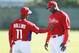 A slimmed-down Ryan Howard talks to Jimmy Rollins during Spring Training.