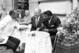 Eddie Eagan (center) and Floyd Patterson listen to Jesse Owens at a restaurant in Rome, 1960.