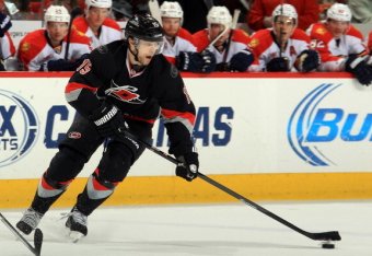 RALEIGH, NC - FEBRUARY 07: Tuomo Ruutu #15 of the Carolina Hurricanes scoops up a loose puck during their NHL game against the Florida Panthers at PNC Arena on February 7, 2014 in Raleigh, North Carolina. (Photo by Gregg Forwerck/NHLI via Getty Images)