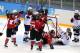 SOCHI, RUSSIA - FEBRUARY 12: Hayley Wickenheiser #22 of Canada celebrates with teammates after scoring a goal in the third period against Jessie Vetter #31 the United States during the Women's Ice Hockey Preliminary Round Group A game on day five of the