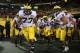 TEMPE, AZ - DECEMBER 28: (L-R) Offensive linesman Taylor Lewan #77, cornerback Courtney Avery #11 and wide receiver Drew Dileo #9 of the Michigan Wolverines lead teammates out onto the field before the Buffalo Wild Wings Bowl against the Kansas State Wil