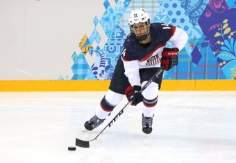 SOCHI, RUSSIA - FEBRUARY 12: Brianna Decker #14 of the United States handles the puck against Canada during the Women's Ice Hockey Preliminary Round Group A game on day five of the Sochi 2014 Winter Olympics at Shayba Arena on February 12, 2014 in Sochi, 