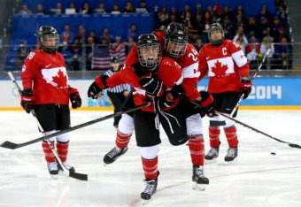 SOCHI, RUSSIA - FEBRUARY 12: Meghan Agosta-Marciano #2 of Canada celebrates after scoring a goal with Natalie Spooner #24 in the third period against the United States during the Women's Ice Hockey Preliminary Round Group A game on day five of the Sochi