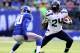 EAST RUTHERFORD, NJ - DECEMBER 15: Marshawn Lynch #24 of the Seattle Seahawks carries the ball as Prince Amukamara #20 of the New York Giants defends at MetLife Stadium on December 15, 2013 in East Rutherford, New Jersey. (Photo by Elsa/Getty Images)