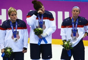 SOCHI, RUSSIA - FEBRUARY 20: (L-R) Silver medalists Brianna Decker #14, Anne Schleper #15 and Kelli Stack #16 of the United States react during the flower ceremony for the Ice Hockey Women's Gold Medal Game on day 13 of the Sochi 2014 Winter Olympics at