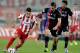 ATHENS,GREECE - FEBRUARY 5: Hernan Perez of Olympiacos F.C. is followed by Pavlos Mitropoulos of Panionios GSS during the Greek Superleague match between Olympiacos F.C. and Panionios GSS at the Karaiskaki Stadium on February 5, 2014 in Piraeus near At