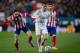 MADRID, SPAIN - FEBRUARY 11: Cristiano Ronaldo (2ndL) of Real Madrid CF competes for the ball with Juan Francisco Torres alias Juanfran (L) of Atletico de Madrid and his teammate Raul Garcia (R) during the Copa del Rey semi-final second leg match between