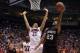SALT LAKE CITY, UT - MARCH 23: Wesley Saunders #23 of the Harvard Crimson goes up for a shot against Brandon Ashley #21 of the Arizona Wildcats in the second half during the third round of the 2013 NCAA Men's Basketball Tournament at EnergySolutions Aren