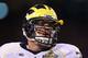 TEMPE, AZ - DECEMBER 28: Offensive linesman Taylor Lewan #77 of the Michigan Wolverines stands on the sidelines during the Buffalo Wild Wings Bowl against the Kansas State Wildcats at Sun Devil Stadium on December 28, 2013 in Tempe, Arizona. The Wildcats
