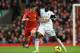 LIVERPOOL, ENGLAND - FEBRUARY 23: Philippe Coutinho of Liverpool competes with Wilfried Bony of Swansea City during the Barclays Premier League match between Liverpool and Swansea City at Anfield on February 23, 2014 in Liverpool, England. (Photo by Cli