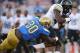 Nov 2, 2013; Pasadena, CA, USA; Colorado Buffaloes tailback Christian Powell (46) is tackled by UCLA Bruins safety Myles Jack (30) at Rose Bowl. UCLA defeated Colorado 45-23. Mandatory Credit: Kirby Lee-USA TODAY Sports
