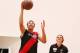 MELBOURNE, AUSTRALIA - FEBRUARY 14: Joe Daniher of the Bombers watches young Australian basketball player Dante Exum drive to the hoop during an Essendon Bombers AFL media session at True Value Solar Centre on February 14, 2014 in Melbourne, Australia.