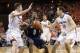 Feb 22, 2014; Charlottesville, VA, USA; Virginia Cavaliers forward Evan Nolte (11) knocks the ball from Notre Dame Fighting Irish guard Eric Atkins (0) as Cavaliers guard Joe Harris (12) defends in the first half at John Paul Jones Arena. The Cavaliers wo