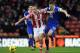 STOKE ON TRENT, ENGLAND - JANUARY 01: Charlie Adam of Stoke City competes with John Stones of Everton during the Barclays Premier League match between Stoke City and Everton at Britannia Stadium on January 01, 2014 in Stoke on Trent, England. (Photo by Ch