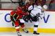 CALGARY, CANADA - FEBRUARY 27: Kevin Westgarth (L) of the Calgary Flames pushes Dustin Brown of the Los Angeles Kings away from the puck during the first period of their NHL hockey game at the Scotiabank Saddledome February 27, 2014 in Calgary, Alberta, C