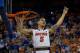 GAINESVILLE, FL - MARCH 08: Scottie Wilbekin #5 of the Florida Gators holds up a piece of the net after the game against the Kentucky Wildcats at the Stephen C. O'Connell Center on March 8, 2014 in Gainesville, Florida. The Gators were 18-0 in the SEC Con