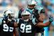 CHARLOTTE, NC - DECEMBER 23: Dwan Edwards #92 of the Carolina Panthers celebrates after a sack with teammate Frank Alexander #90 during their game against the Oakland Raiders at Bank of America Stadium on December 23, 2012 in Charlotte, North Carolina.
