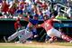JUPITER, FL - MARCH 2: Ed Easley #72 of the St Louis Cardinals tags Brandon Nimmo #77 of the New York Mets out at home in the eighth inning during a spring training game at Roger Dean Stadium on March 2, 2014 in Jupiter, Florida. The Cardinals defeated th