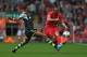 LIVERPOOL, ENGLAND - AUGUST 17: Jose Enrique of Liverpool passes the ball past Steven N'Zonzi of Stoke City during the Barclays Premier League match between Liverpool and Stoke City at Anfield on August 17, 2013 in Liverpool, England. (Photo by Clive Brun