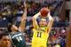 INDIANAPOLIS, IN - MARCH 16: Nik Stauskas #11 of the Michigan Wolverines looks to pass as Gary Harris #14 of the Michigan State Spartans defends during the 2014 Big Ten Men's Championship at Bankers Life Fieldhouse on March 16, 2014 in Indianapolis, India