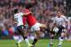 MANCHESTER, ENGLAND - MARCH 16: Marouane Fellaini of Manchester United tangles with Raheem Sterling of Liverpool during the Barclays Premier League match between Manchester United and Liverpool at Old Trafford on March 16, 2014 in Manchester, England. (