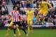 SUNDERLAND, ENGLAND - MARCH 15 : KI Sung Yueng of Sunderland and Adlene Guedioura of Crystal Palace challenge during the Barclays English Premier League match between Sunderland and Crystal Palace at the Stadium of Light on March 15 2014 in Sunderland, En