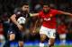 MANCHESTER, ENGLAND - MARCH 19: Antonio Valencia of Manchester United competes with Giannis Maniatis of Olympiacos during the UEFA Champions League Round of 16 second round match between Manchester United and Olympiacos FC at Old Trafford on March 19, 20
