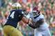 SOUTH BEND, IN - SEPTEMBER 28: Jordan Phillips #80 of the Oklahoma Sooners rushes against Christian Lombard #74 of the Notre Dame Fighting Irish at Notre Dame Stadium on September 28, 2013 in South Bend, Indiana. Oklahoma defeated Notre Dame 35-21. (Pho
