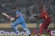 DHAKA, BANGLADESH - MARCH 23: Virat Kohli of India bats as Denesh Ramdin of the West Indies looks on during the ICC World Twenty20 Bangladesh 2014 match between the West Indies and India at Sher-e-Bangla Mirpur Stadium on March 23, 2014 in Dhaka, Banglad