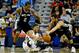 Jan 13, 2014; New Orleans, LA, USA; New Orleans Pelicans shooting guard Eric Gordon (10) passes as San Antonio Spurs shooting guard Marco Belinelli (3) and small forward Kawhi Leonard (2) pressure on defense during the second quarter of a game at the New