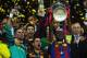 LONDON, ENGLAND - MAY 28: (L-R) Victor Valdes, Gerard Pique and Xavi celebrate as teammate Eric Abidal of FC Barcelona lifts the trophy during the UEFA Champions League final between FC Barcelona and Manchester United FC at Wembley Stadium on May 28, 201