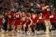 ANAHEIM, CA - MARCH 29: Traevon Jackson #12 and Frank Kaminsky #44 of the Wisconsin Badgers celebrate with teammates after defeating the Arizona Wildcats 64-63 in overtime during the West Regional Final of the 2014 NCAA Men's Basketball Tournament at the