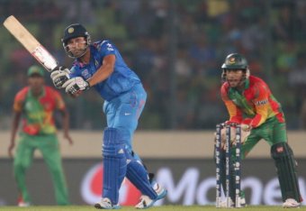 DHAKA, BANGLADESH - MARCH 28:  Rohit Sharma of India bats as Mushfiqur Rahim of Bangladesh looks on during the ICC World Twenty20 Bangladesh 2014 match between Bangladesh and India at Sher-e-Bangla Mirpur Stadium on March 28, 2014 in Dhaka, Bangladesh.  (