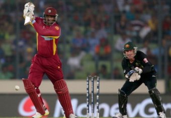 DHAKA, BANGLADESH - MARCH 28:  Chris Gayle of the West Indies bats as Brad Haddin of Australia looks on during the ICC World Twenty20 Bangladesh 2014 match between Australia and the West Indies at Sher-e-Bangla Mirpur Stadium on March 28, 2014 in Dhaka, B