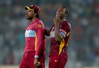 DHAKA, BANGLADESH - APRIL 01:  Andre Russell of the West Indies celebrates with Chris Gayle after dismissing Mohammad Hafeez of Pakistan during the ICC World Twenty20 Bangladesh 2014 match between West Indies and Pakistan at Sher-e-Bangla Mirpur Stadium o