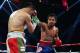 MACAU - NOVEMBER 24: Manny Pacquiao (R) of the Philippines punches Brandon Rios of the U.S. during their 'Clash in Cotai' WBO International Welterweight title fight on November 24, 2013 in Macau. (Photo by Nicky Loh/Getty Images)