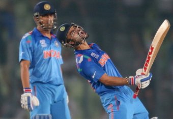 DHAKA, BANGLADESH - APRIL 04: Virat Kohli of India screams after he hit the winning runs as MS Dhoni looks on as India win the ICC World Twenty20 Bangladesh 2014 2nd Semi-Final match between India and South Africa at Sher-e-Bangla Mirpur Stadium on April