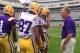 LSU offensive coordinator Cam Cameron (right) speaks with his receivers before the spring game.