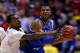 INDIANAPOLIS, IN - MARCH 28: Russ Smith #2 of the Louisville Cardinals defends Andrew Harrison #5 of the Kentucky Wildcats during the regional semifinal of the 2014 NCAA Men's Basketball Tournament at Lucas Oil Stadium on March 28, 2014 in Indianapolis,