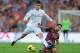 BARCELONA, SPAIN - OCTOBER 26: Cristiano Ronaldo of Real Madrid CF (L) is tackled by Xavi Hernandez of FC Barcelona during the La Liga match between FC Barcelona and Real Madrid CF at Camp Nou stadium on October 26, 2013 in Barcelona, Spain. (Photo by D