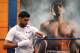 BOLTON, ENGLAND - MARCH 24: Amir Khan tapes his hands up prior to a media workout at the Gloves Community Centre on March 24, 2014 in Bolton, England. (Photo by Alex Livesey/Getty Images)