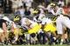 Oct 12, 2013; University Park, PA, USA; Michigan Wolverines offensive linesmen Graham Glasgow (61) prepares to snap the ball to quarterback Devin Gardner (98) during the fourth quarter against the Penn State Nittany Lions at Beaver Stadium. Penn State def