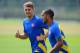 ST ALBANS, ENGLAND - AUGUST 26: Aaron Ramsey and Theo Walcott of Arsenal warm up during a training session ahead of their UEFA Champions League Play Off second leg match against Fenerbache at London Colney on August 26, 2013 in St Albans, England. (Photo