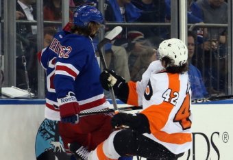 NEW YORK, NY - APRIL 17: Jason Akeson #42 of the Philadelphia Flyers takes a four minute penalty for highsticking Carl Hagelin #62 of the New York Rangers in Game One of the First Round of the 2014 NHL Stanley Cup Playoffs at Madison Square Garden on Apr