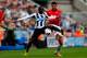 NEWCASTLE UPON TYNE, ENGLAND - APRIL 05: Papiss Demba Cisse (L) of Newcastle in action with Chris Smalling of Manchester United during the Barclays Premier League match between Newcastle United and Manchester United at St James' Park on April 5, 2014 in N
