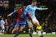 MANCHESTER, ENGLAND - DECEMBER 28: Jason Puncheon of Crystal Palace competes with Edin Dzeko of Manchester City during the Barclays Premier League match between Manchester City and Crystal Palace at the Etihad Stadium on December 28, 2013 in Manchester,