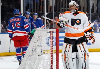 NEW YORK, NY - APRIL 20: Ray Emery #29 of the Philadelphia Flyers looks on as Benoit Pouliot #67 and the New York Rangers celebrate after a first-period goal in Game Two of the First Round of the 2014 Stanley Cup Playoffs at Madison Square Garden on Apri