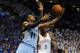 Apr 21, 2014; Oklahoma City, OK, USA; Memphis Grizzlies guard Mike Conley (11) attempts a reverse layup against Oklahoma City Thunder forward Serge Ibaka (9) during the first quarter in game two during the first round of the 2014 NBA Playoffs at Chesapeak