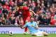 LIVERPOOL, ENGLAND - APRIL 13: Luis Suarez of Liverpool tangles with Martin Demichelis of Manchester City during the Barclays Premier League match between Liverpool and Manchester City at Anfield on April 13, 2014 in Liverpool, England. (Photo by Alex L